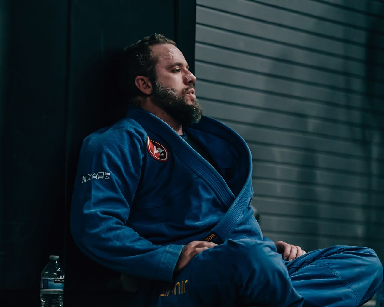 Spencer Thornock seated in a blue Brazilian Jiu-Jitsu gi